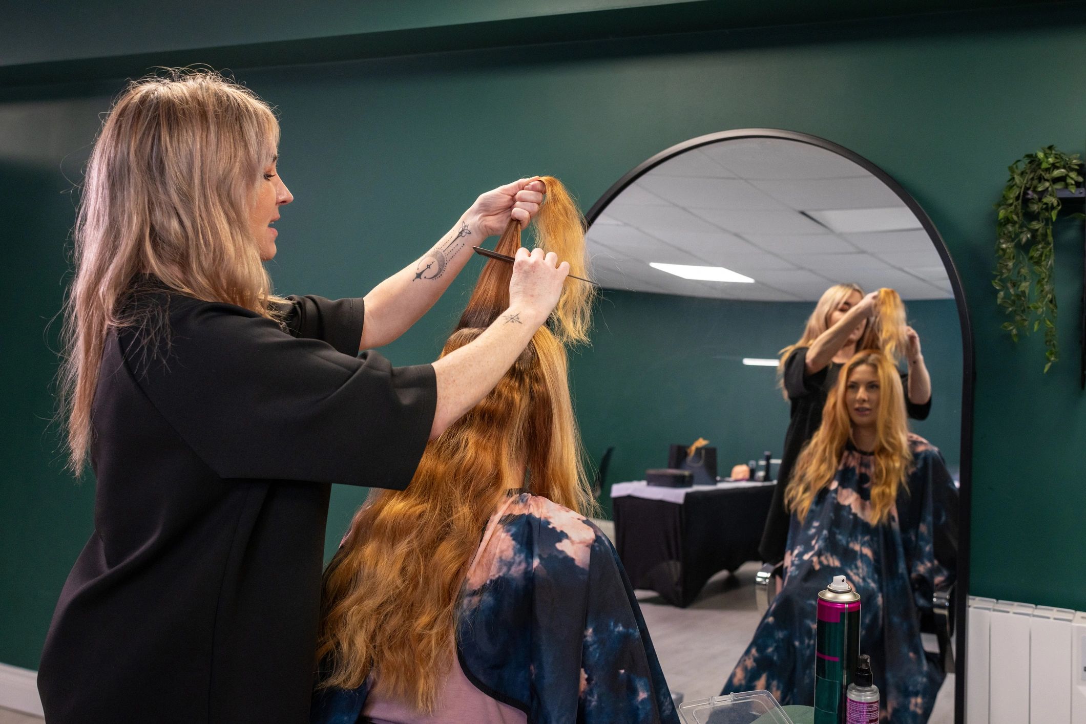 Hair stylist finishing a client's salon service