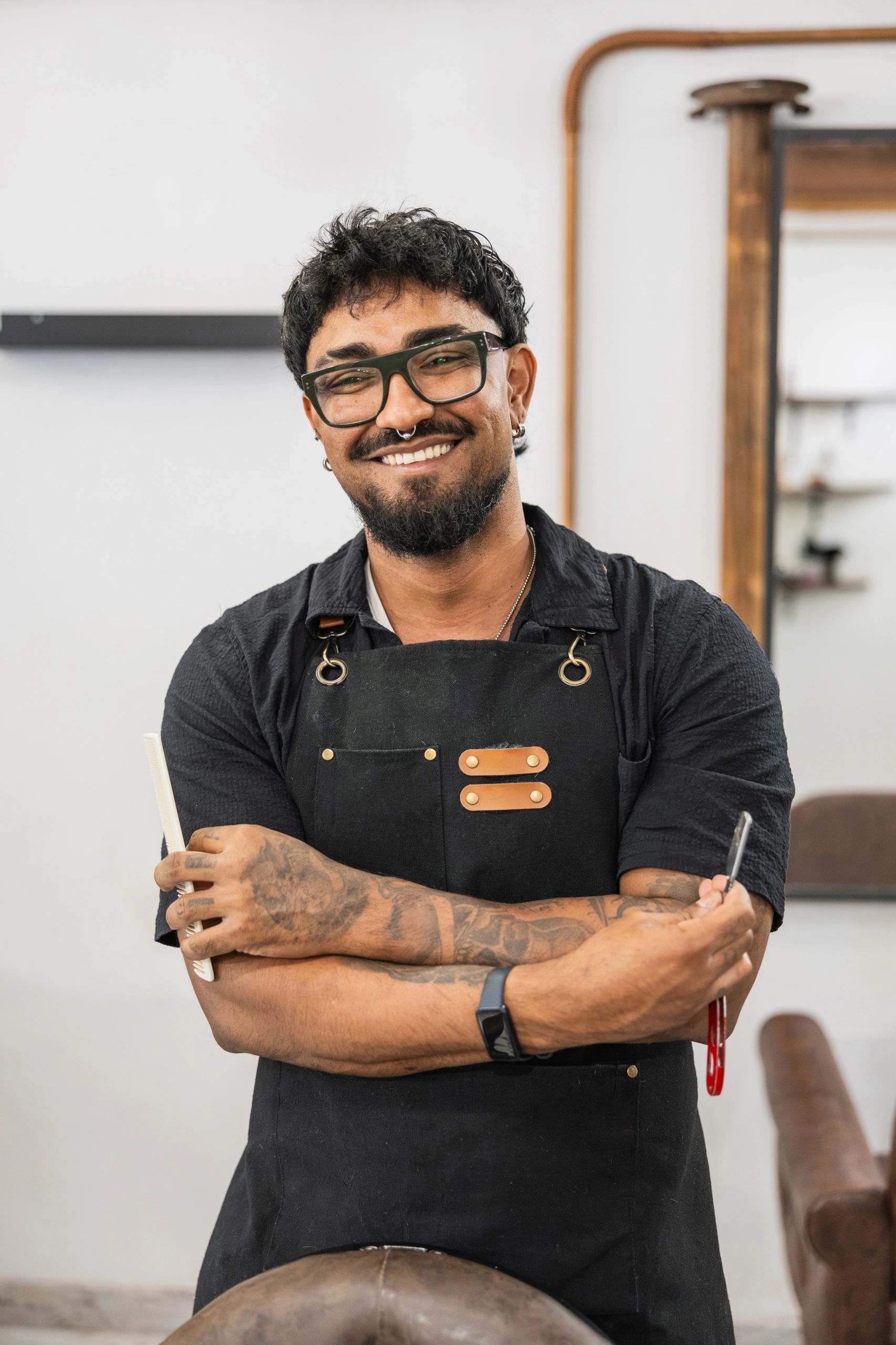 Salon professional standing with styling tools